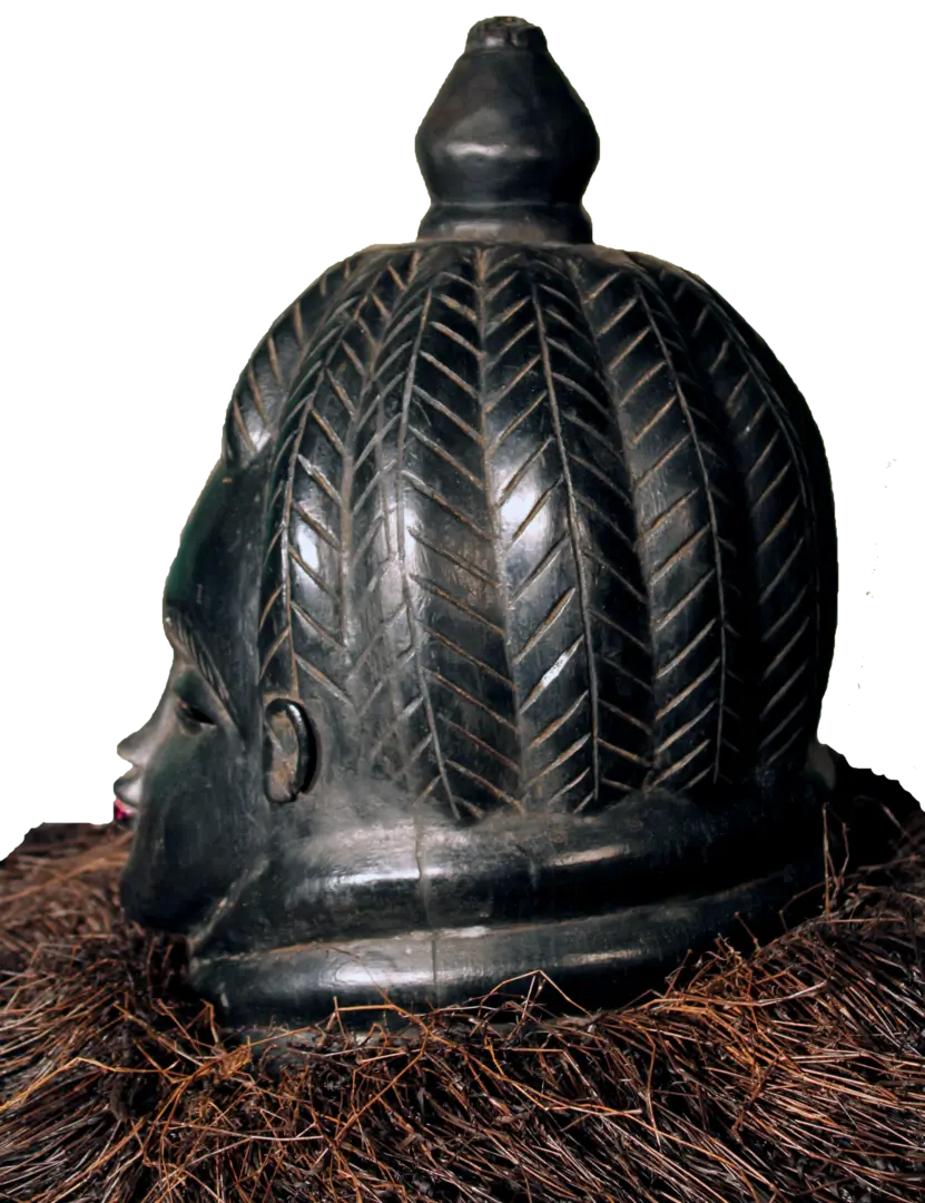 Side view of the Mende Bundu mask on a table